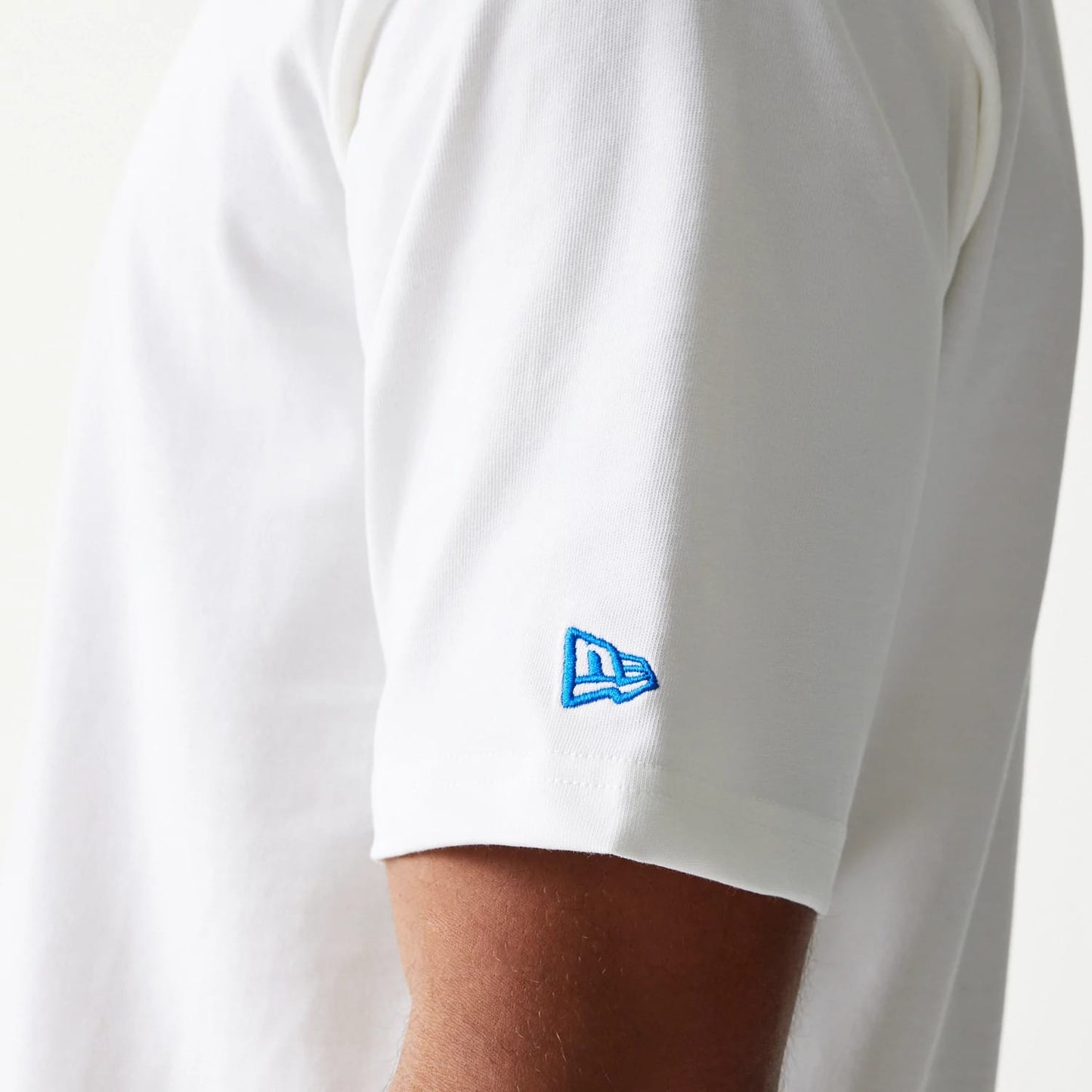 The model is wearing this New Era Script Oversized T-Shirt in white. 6