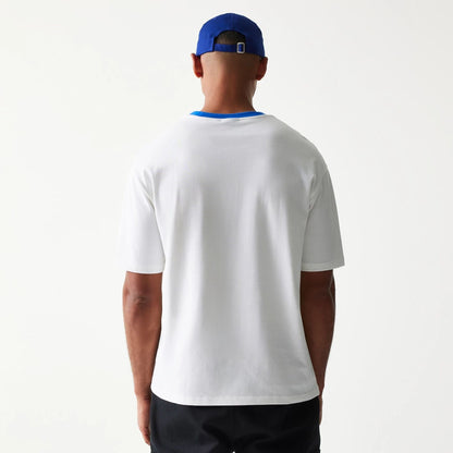 The model is wearing this New Era Script Oversized T-Shirt in white. 2