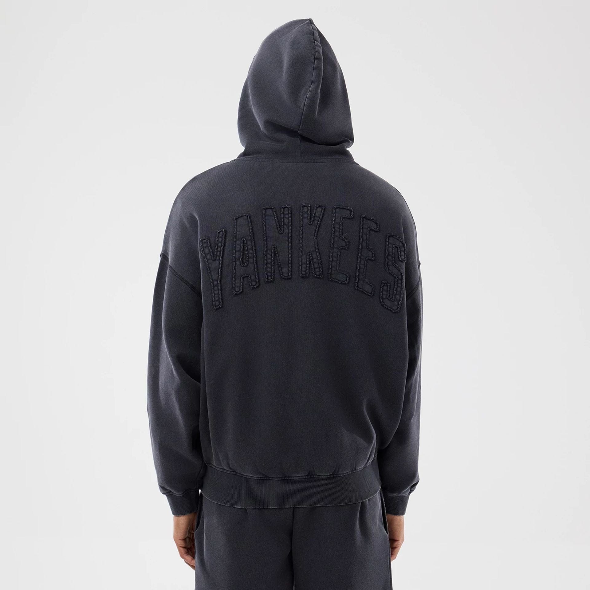 The model is wearing this MLB Washed New York Yankees Full Zip Hoodie in black. 2