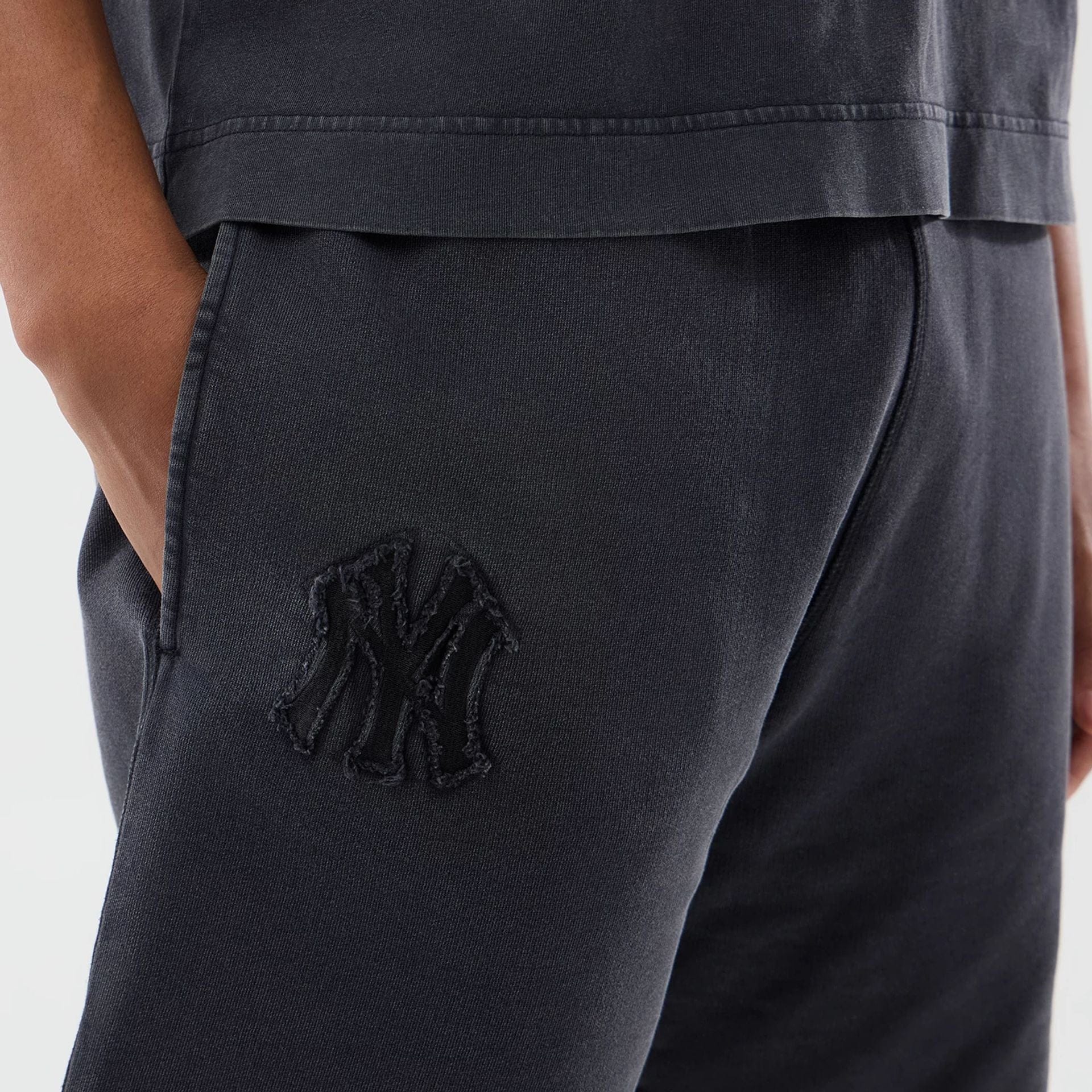 The model is wearing this MLB Washed New York Yankees Shorts in black. 3