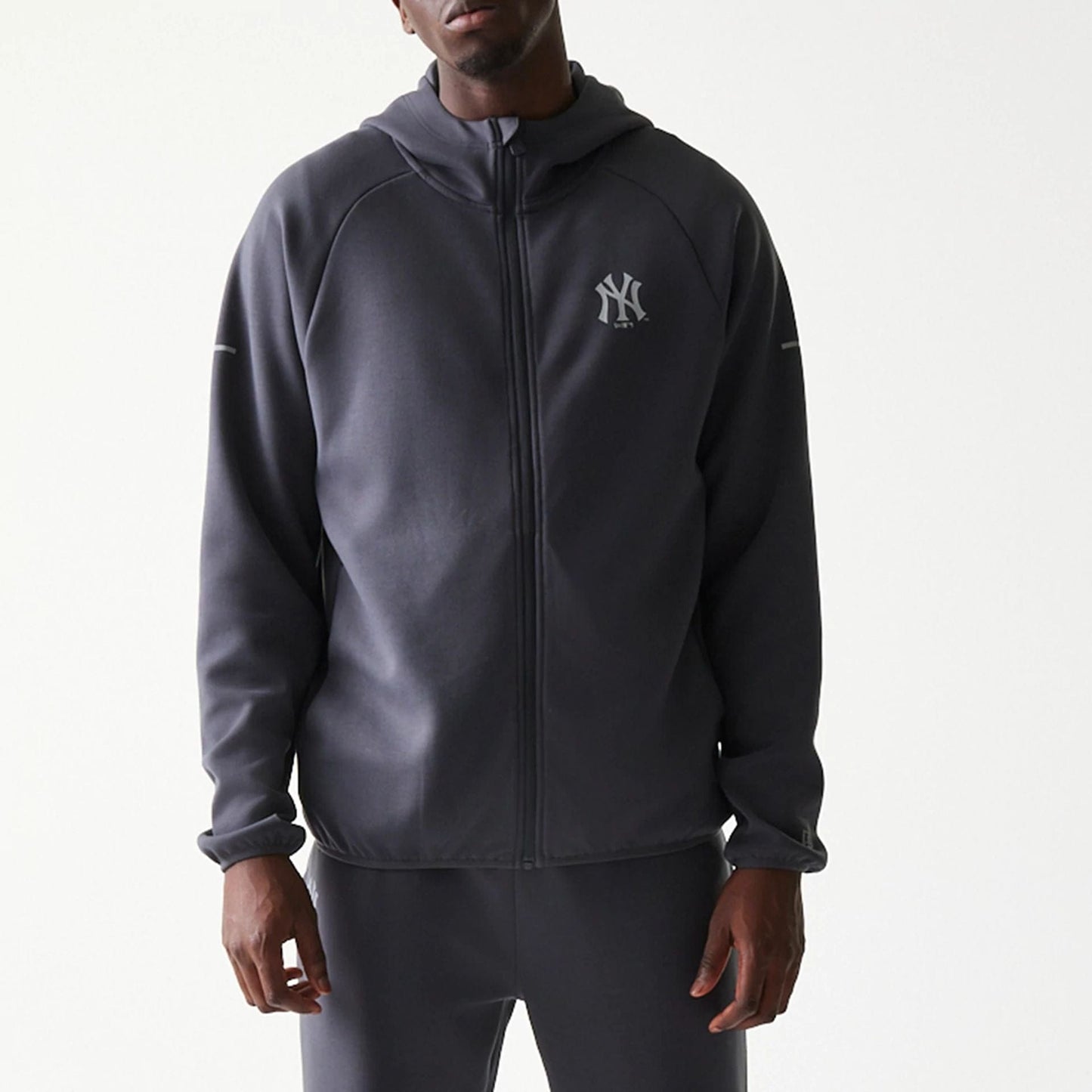 The model is wearing this MLB New York Yankees Full Zip Hoodie in dark grey. 3
