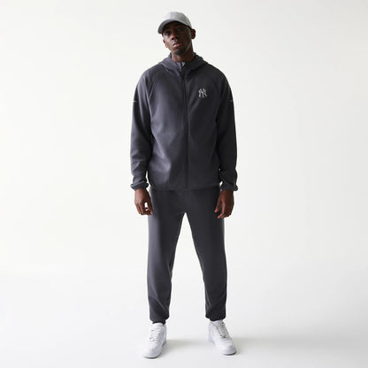 New Era New York Yankees MLB Dark Grey Full Zip Hoodie, front view on-model with matching dark grey joggers and a light grey cap, featuring an embroidered Yankees logo on the left chest and a full-length zip running down the centre.