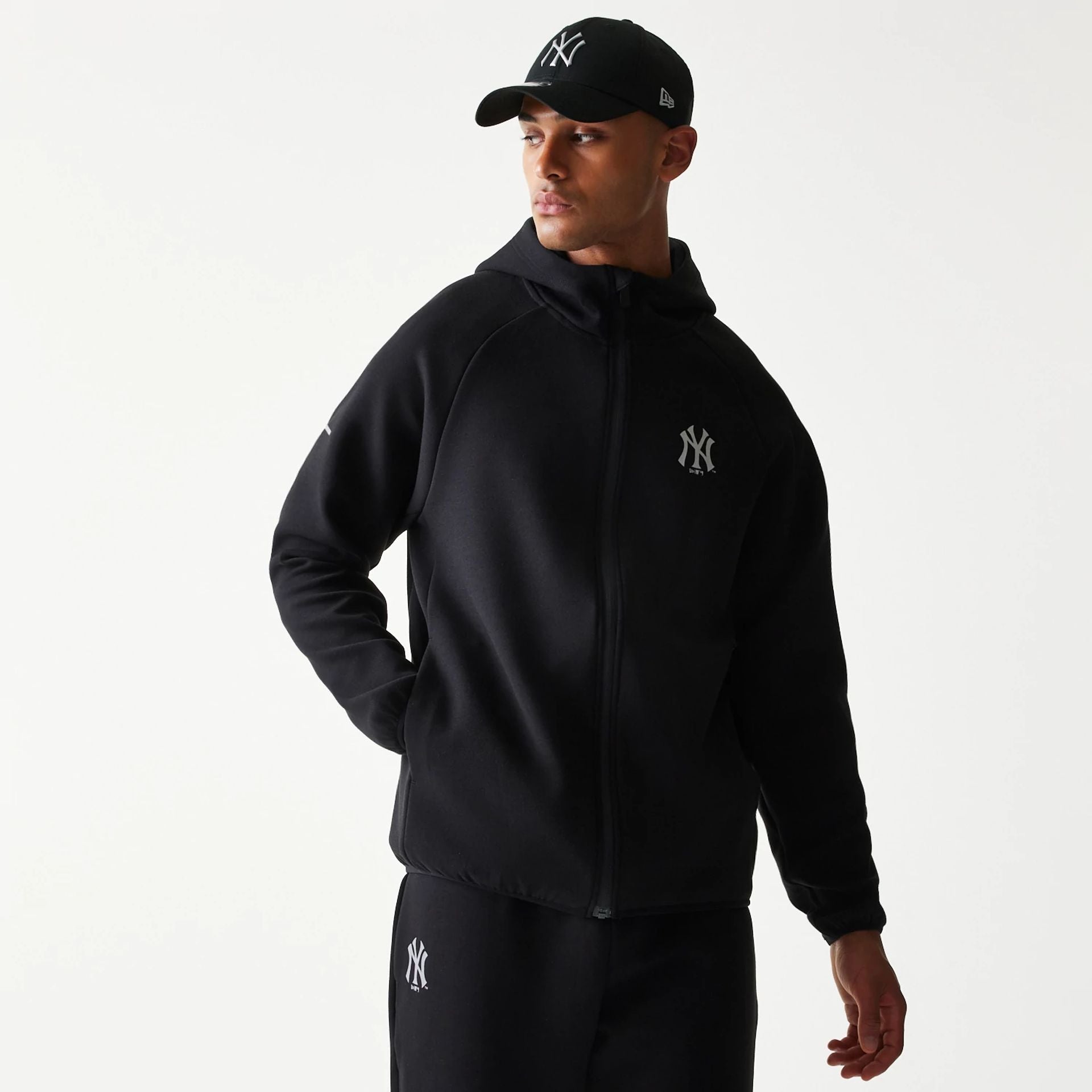 The model is wearing this MLB New York Yankees Full Zip Hoodie in black. 1