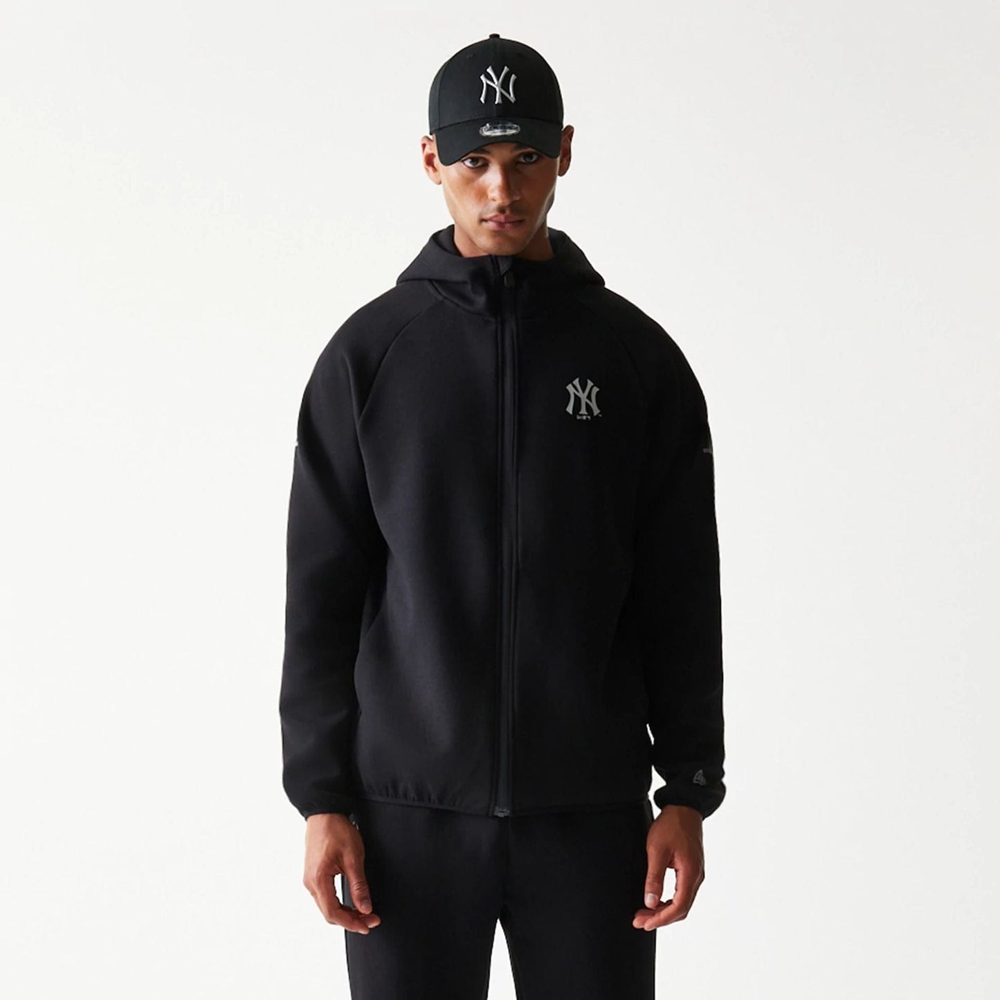 The model is wearing this MLB New York Yankees Full Zip Hoodie in black. 3