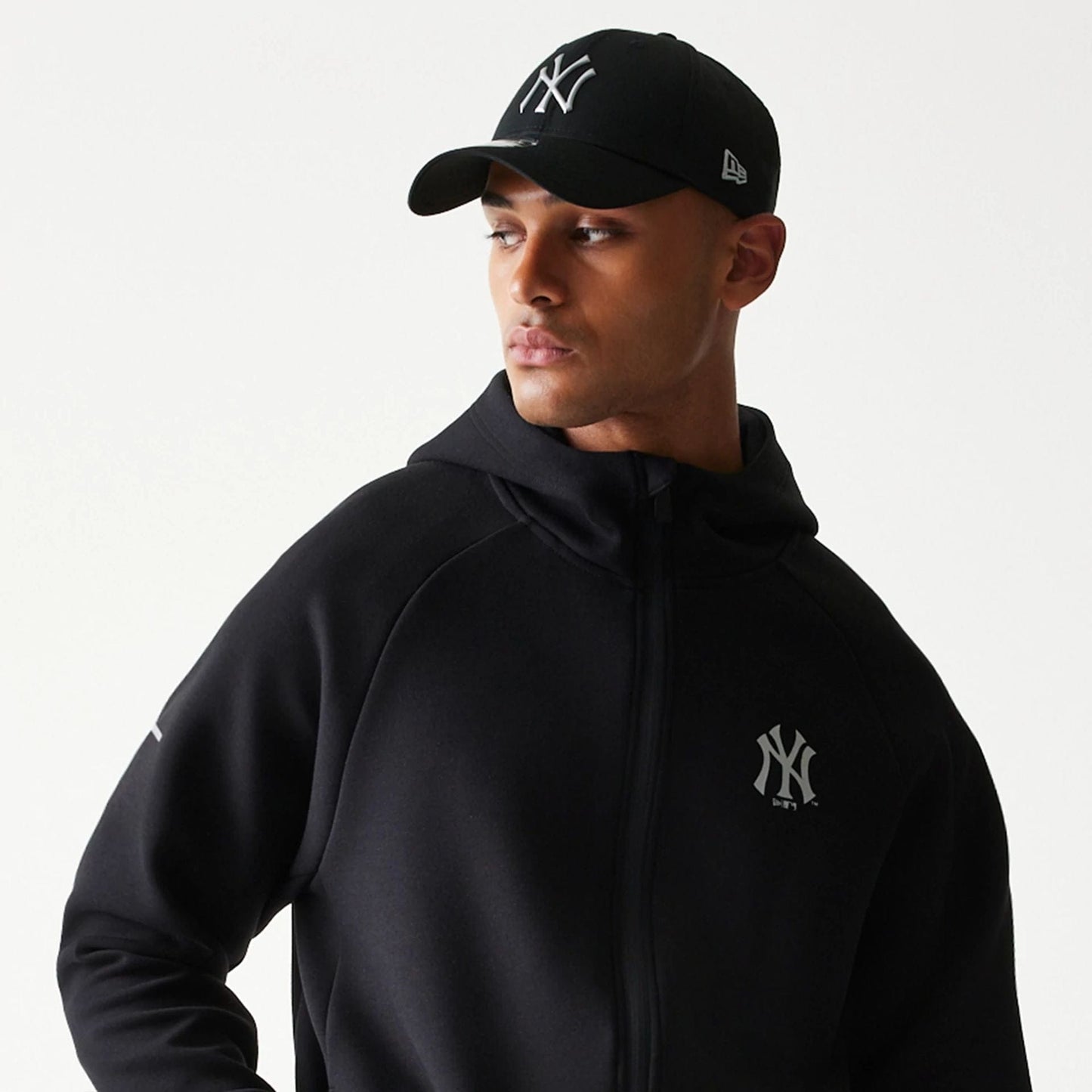 The model is wearing this MLB New York Yankees Full Zip Hoodie in black. 6