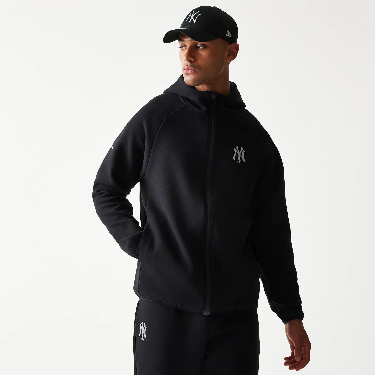 The model is wearing this MLB New York Yankees Full Zip Hoodie in black. 1