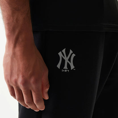 New Era New York Yankees MLB Black Joggers, close-up view showing the grey New York Yankees logo printed on the left leg, with a relaxed fit and part of the New Era branding below the team logo.