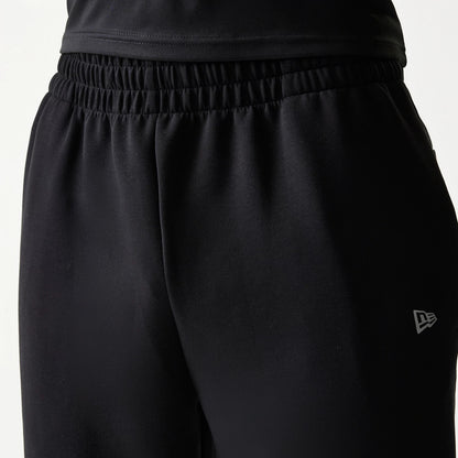 New Era New York Yankees MLB Black Joggers, close-up showing the elastic waistband and the New Era flag logo embroidered in white on the upper left thigh, highlighting the black fabric.