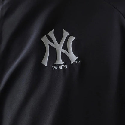 The model is wearing this MLB Reflective Strip New York Yankees Jacket in black. 5