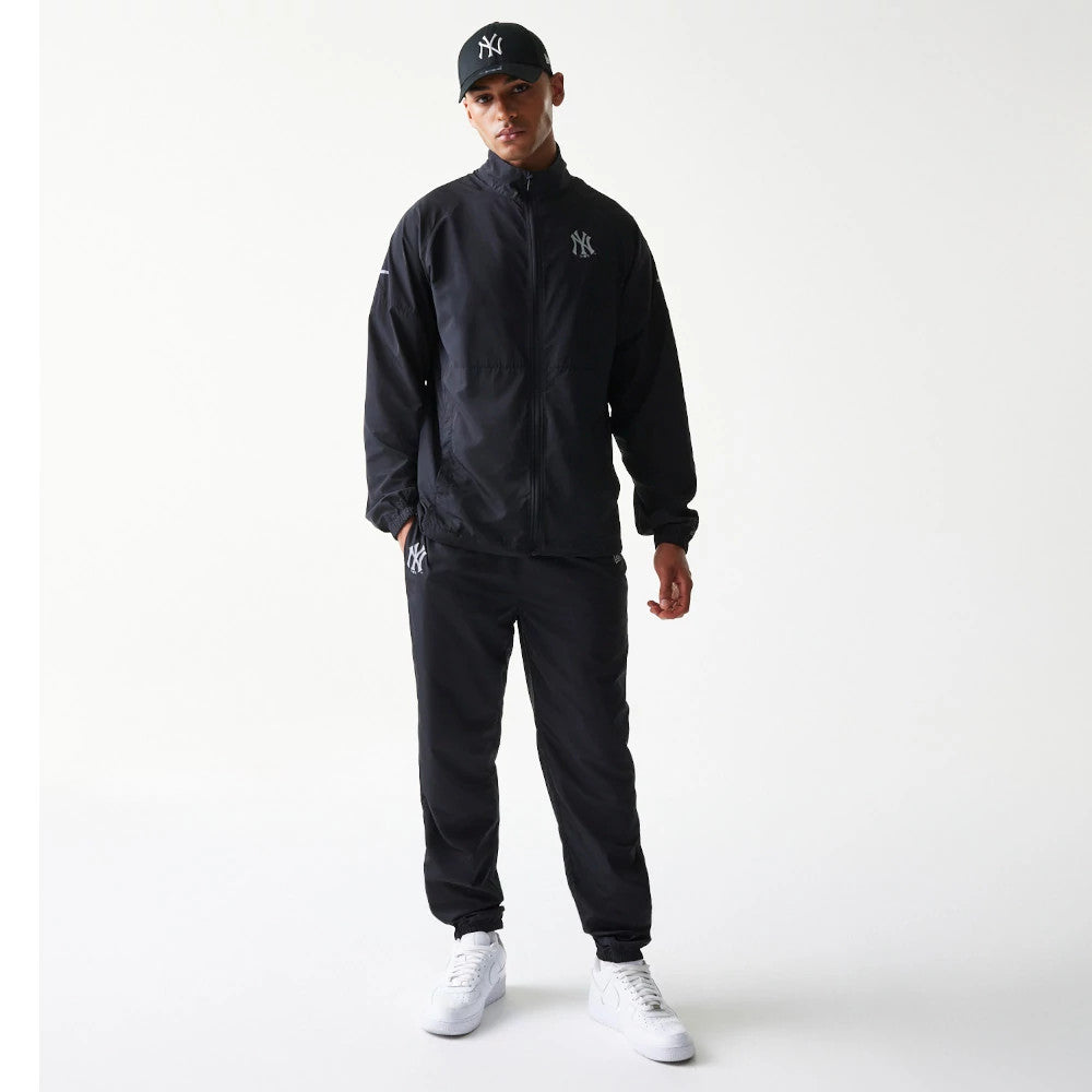 The model is wearing this MLB Reflective Strip New York Yankees Jacket in black. 8