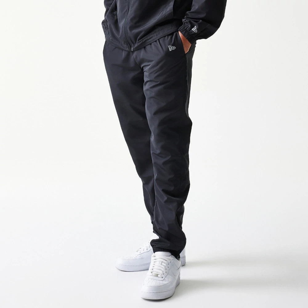 The model is wearing this MLB Reflective Logo New York Yankees Track Pants in black. 7