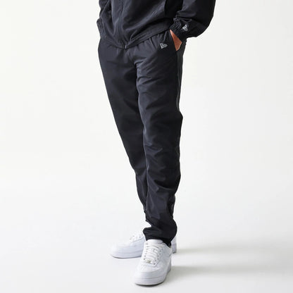 The model is wearing this MLB Reflective Logo New York Yankees Track Pants in black. 7