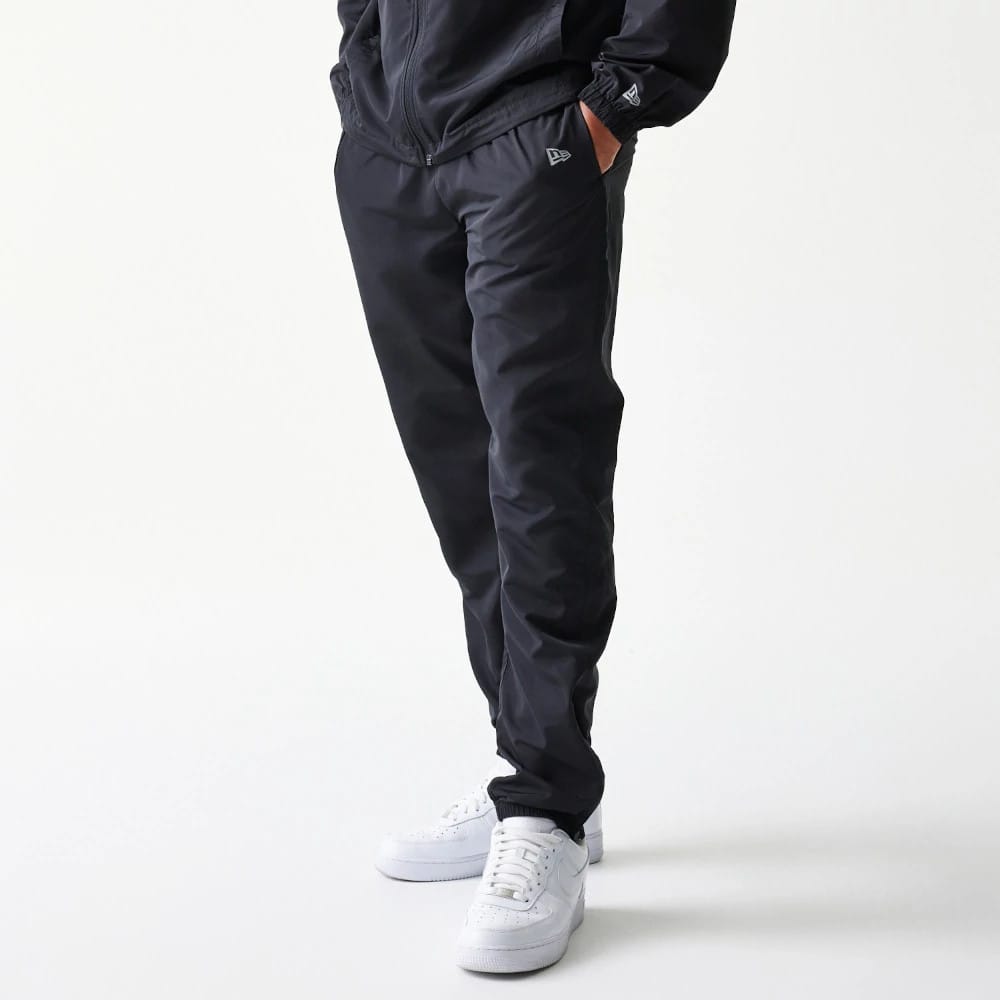 The model is wearing this MLB Reflective Logo New York Yankees Track Pants in black. 7