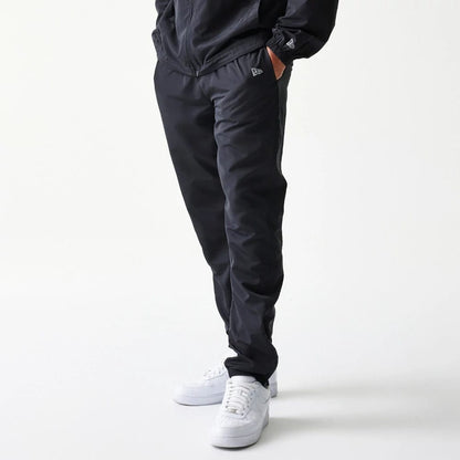 The model is wearing this MLB Reflective Logo New York Yankees Track Pants in black. 7