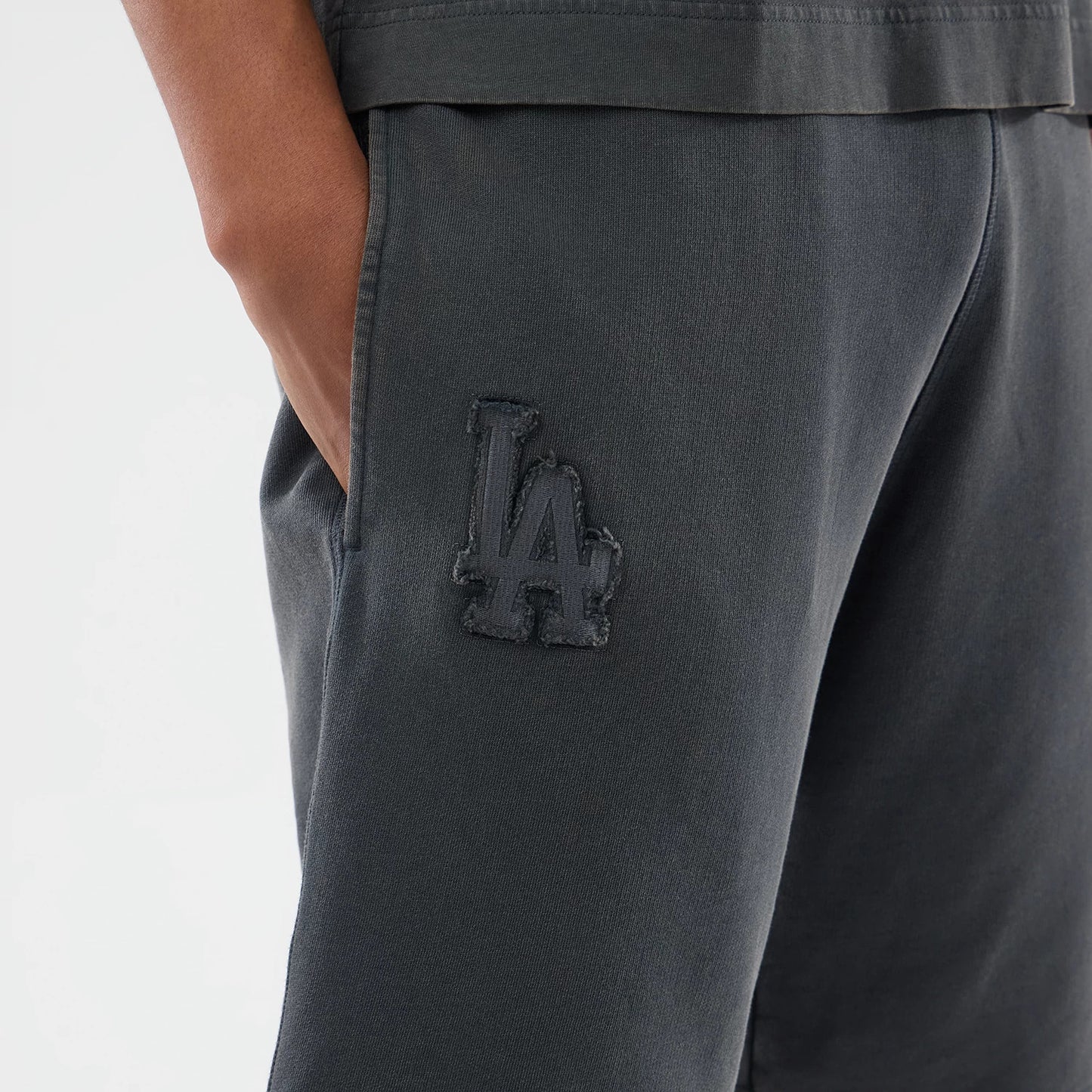 The model is wearing this MLB Washed LA Dodgers Shorts in Dark Grey. 3