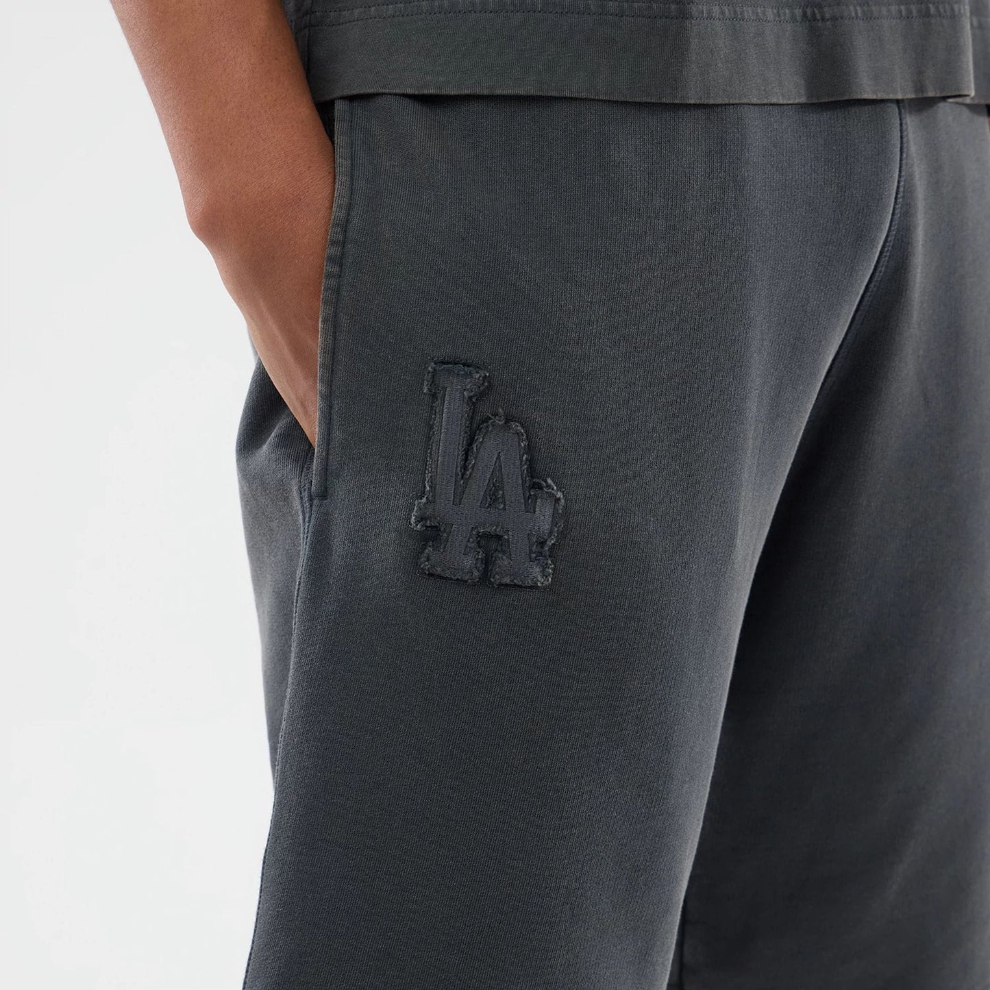The model is wearing this MLB Washed LA Dodgers Shorts in Dark Grey. 3
