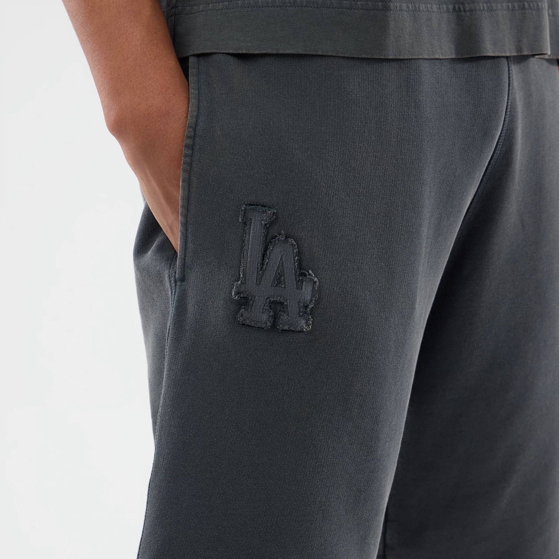 The model is wearing this MLB Washed LA Dodgers Shorts in Dark Grey. 3