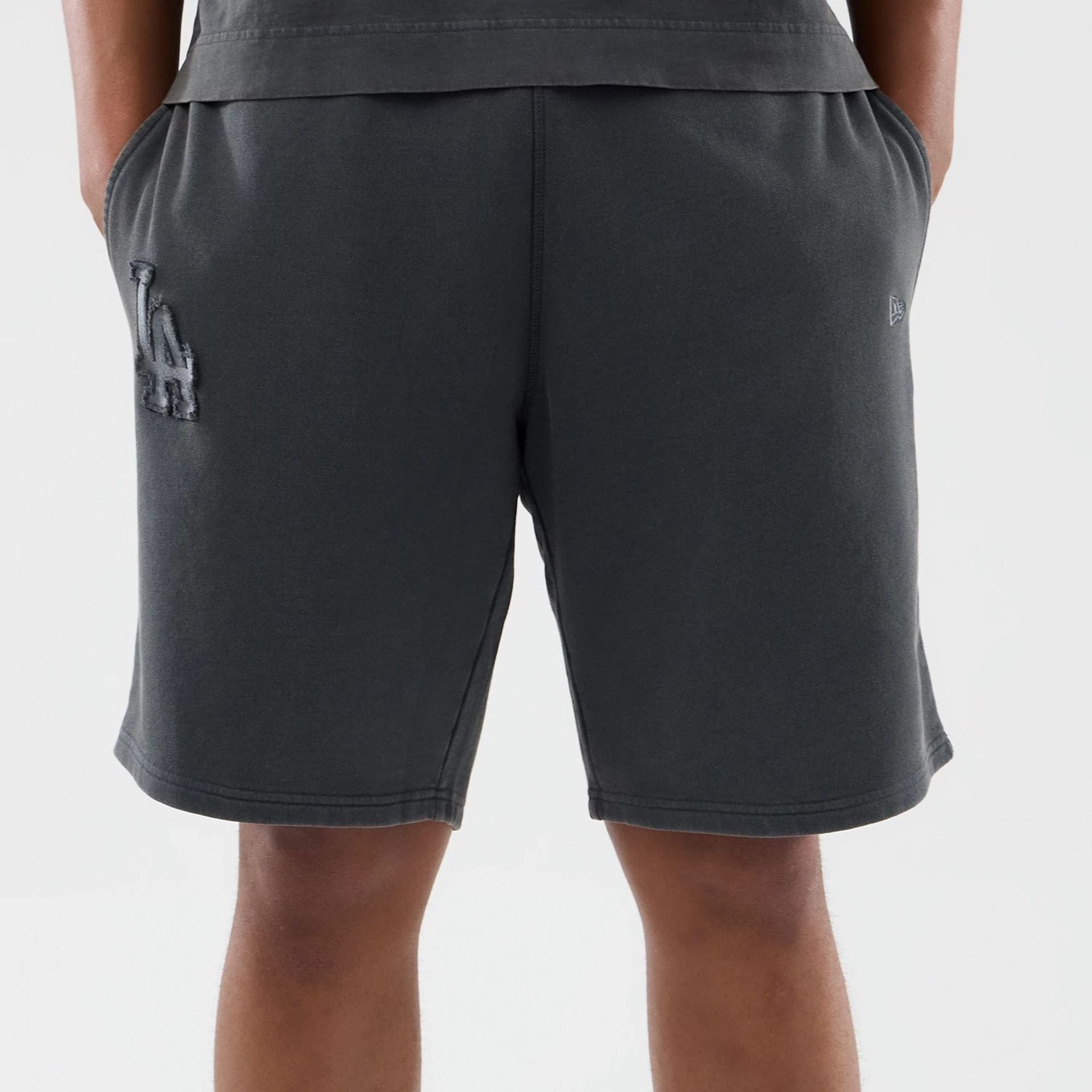 The model is wearing this MLB Washed LA Dodgers Shorts in Dark Grey. 5