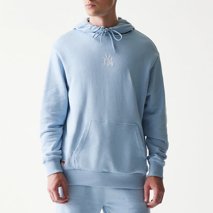 The model is wearing this MLB League Essential Midi New York Yankees Oversized Pullover Hoodie in pastel blue. 3