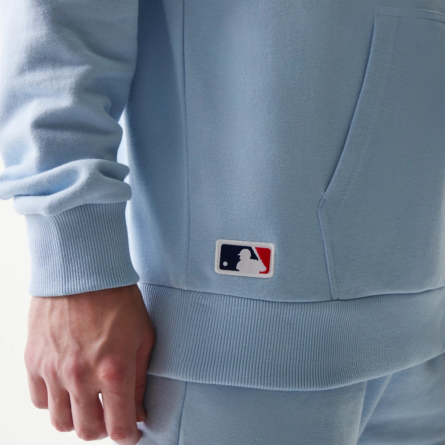 The model is wearing this MLB League Essential Midi New York Yankees Oversized Pullover Hoodie in pastel blue. 6