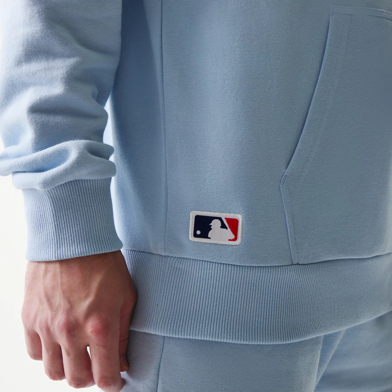 The model is wearing this MLB League Essential Midi New York Yankees Oversized Pullover Hoodie in pastel blue. 6