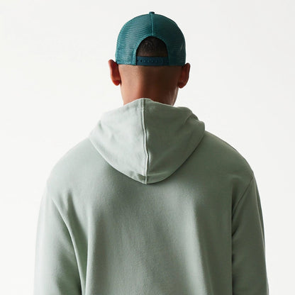 The model is wearing this MLB League Essential Midi LA Dodgers Oversized Pullover Hoodie in green. 7