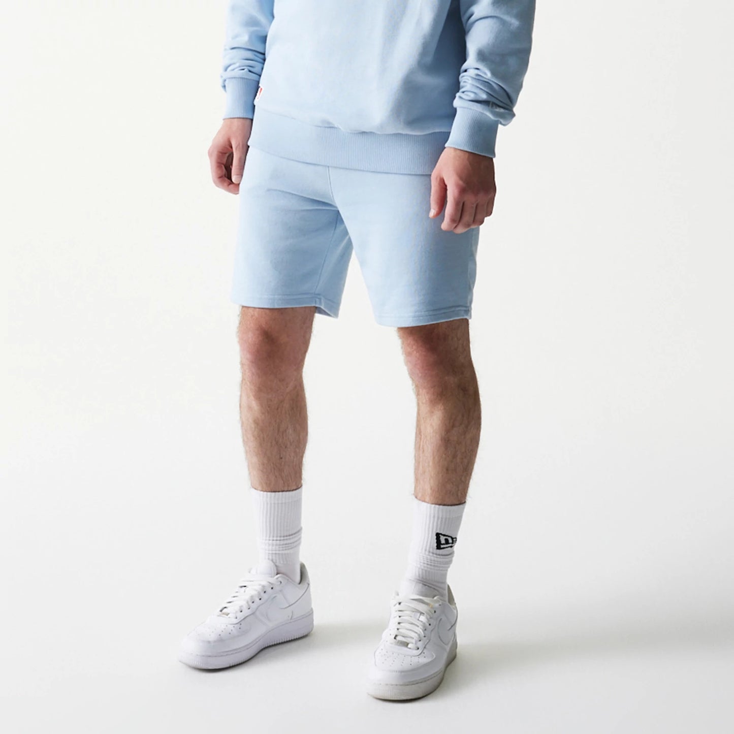 The model is wearing this MLB League Essential Midi New York Yankees Shorts in blue. 3