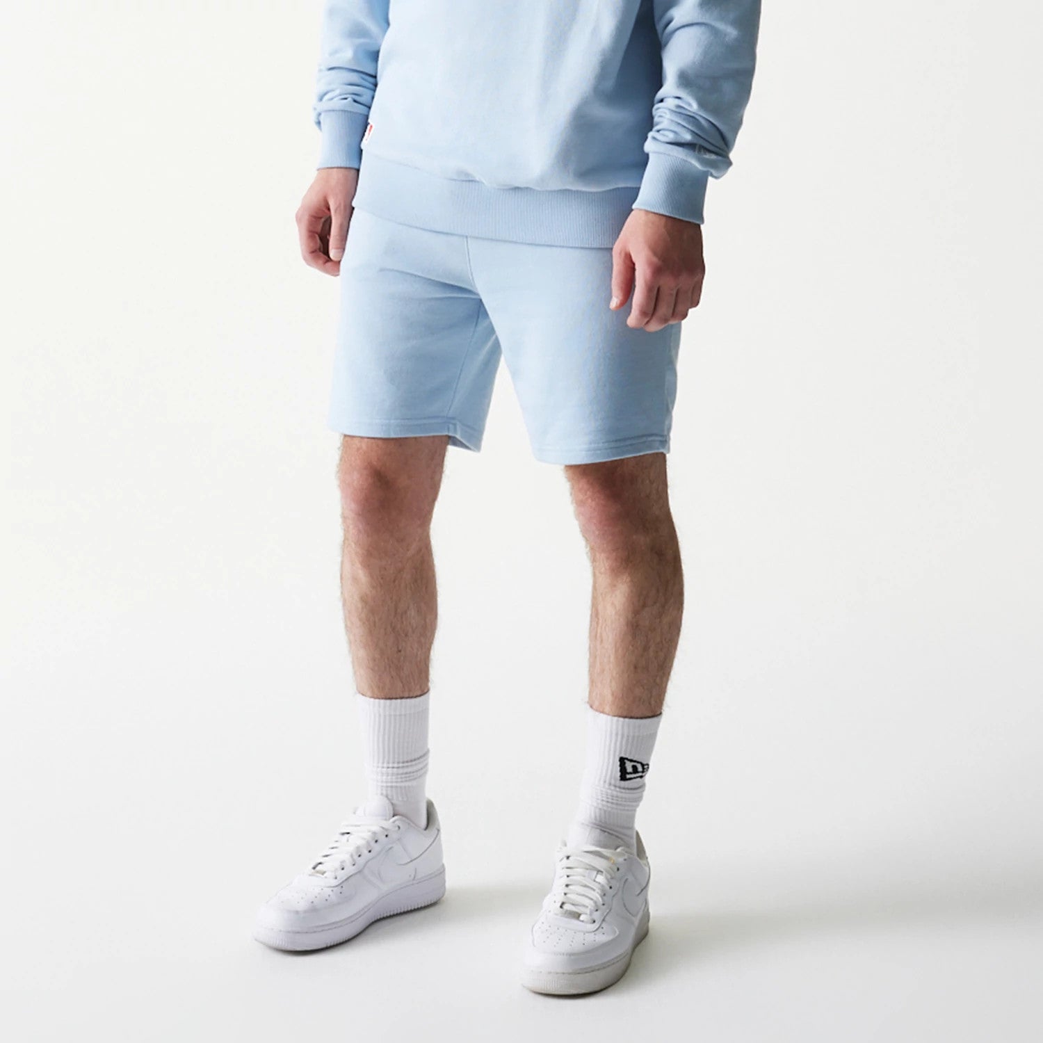 The model is wearing this MLB League Essential Midi New York Yankees Shorts in blue. 3