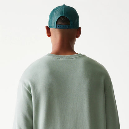 The model is wearing this MLB League Essential Midi LA Dodgers Oversized Crew Neck Sweater in green. 7