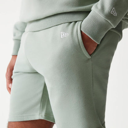 The model is wearing this MLB League Essential Midi LA Dodgers Shorts in green. 4