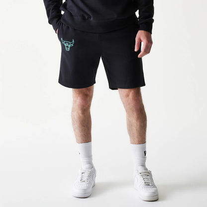 New Era Chicago Bulls NBA Core Black Shorts, front view displaying black shorts with an embroidered turquoise Chicago Bulls logo on the left leg, styled simply with white sneakers and socks.
