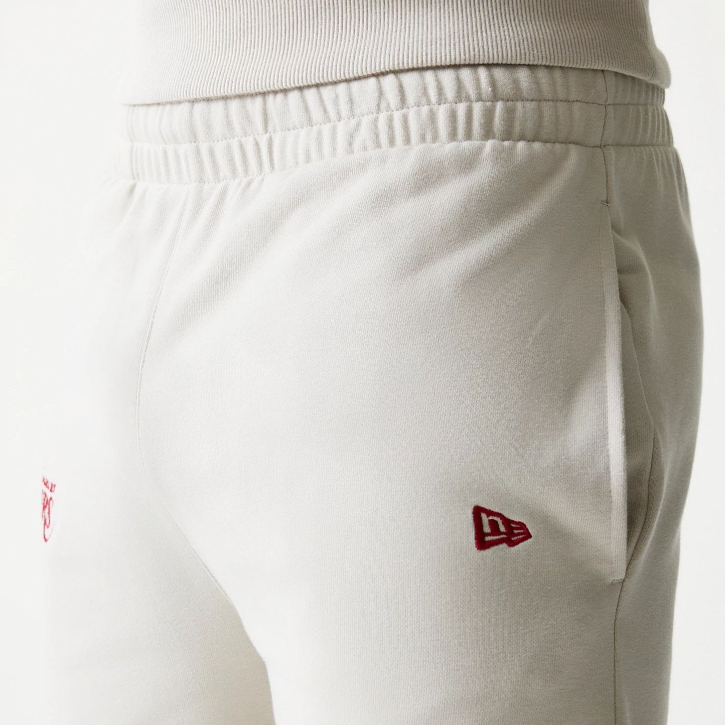 The model is wearing this NBA League Essential LA Lakers Shorts in light beige. 5