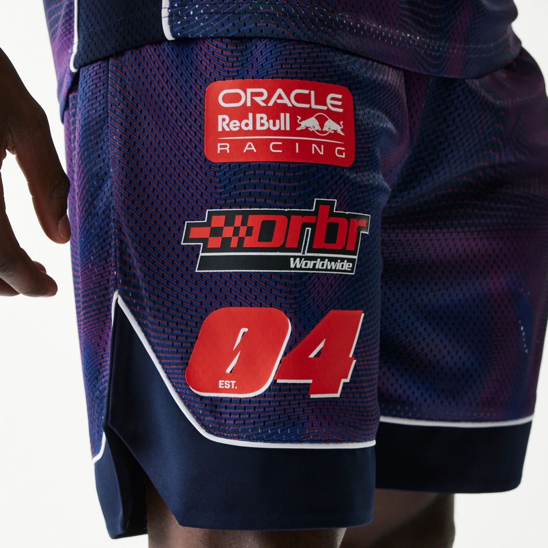 The model is wearing this Red Bull Racing Oversized Mesh Shorts in dark blue. 3