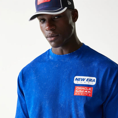 New Era Red Bull Racing Linear Graphic Blue Oversized T-Shirt, front view on-model showing a blue finish with an embroidered New Era logo above an Oracle Red Bull Racing graphic patch on the chest.