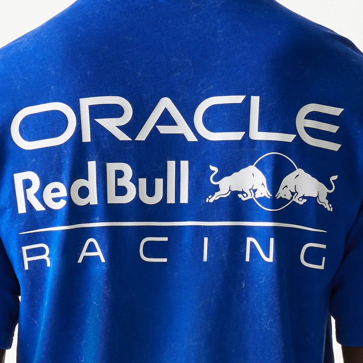 New Era Red Bull Racing Linear Graphic Blue Oversized T-Shirt, back view displaying large white printed Oracle and Red Bull logos across the shoulders with the charging bulls and Racing text below on a vivid blue background.