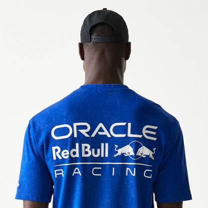 New Era Red Bull Racing Linear Graphic Blue Oversized T-Shirt, back view on a model showing large white Oracle Red Bull Racing lettering with graphic bulls printed across the upper back against a blue background.