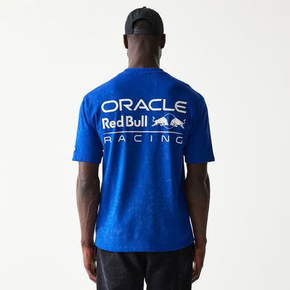 New Era Red Bull Racing Linear Graphic Blue Oversized T-Shirt, back view on a model with a plain cap, showing the large white printed Oracle Red Bull Racing logo spread across the shoulders of the bright blue fabric.