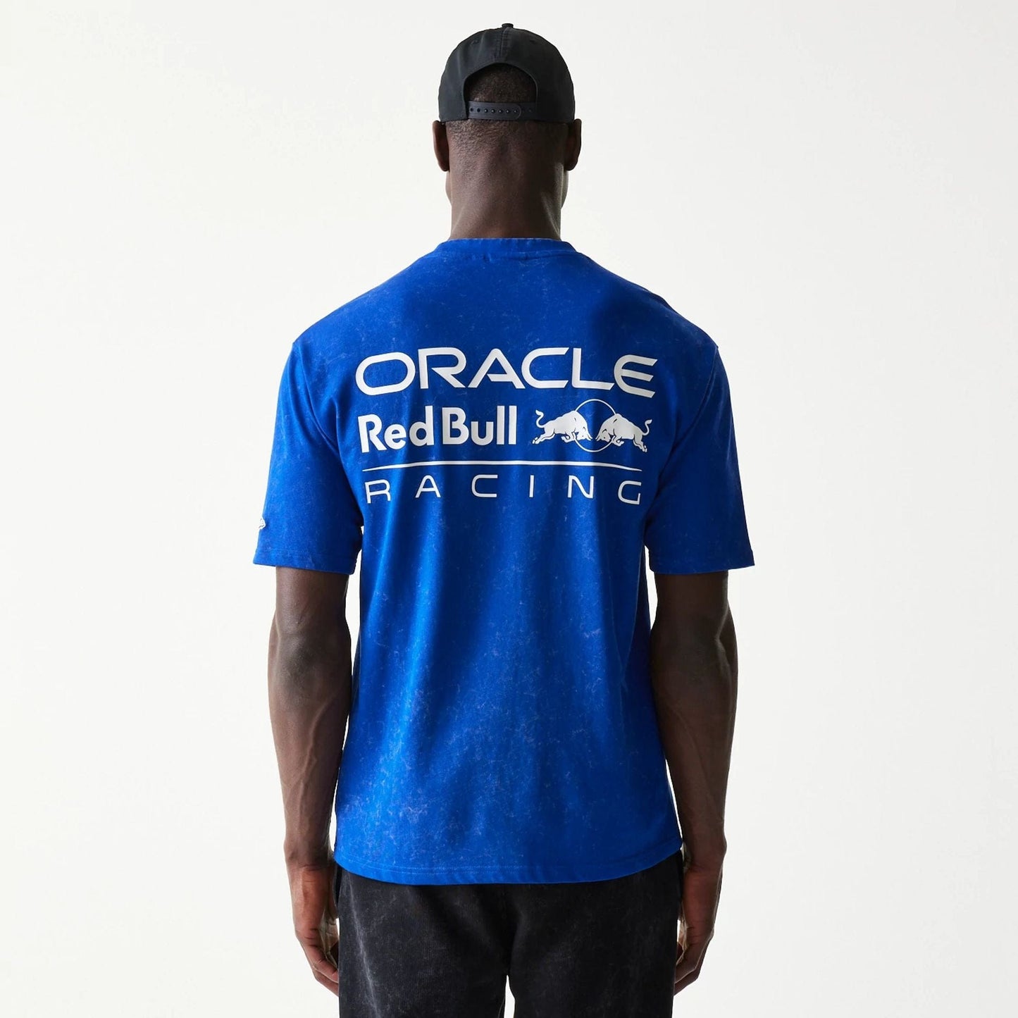 The model is wearing this Red Bull Racing Linear Graphic Oversized T-Shirt in blue. 2
