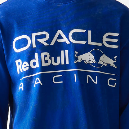 New Era Red Bull Racing Linear Graphic Blue Long Sleeve T-Shirt, back view showing the large white text Oracle above Red Bull with the bull graphic and Racing below across the blue fabric.