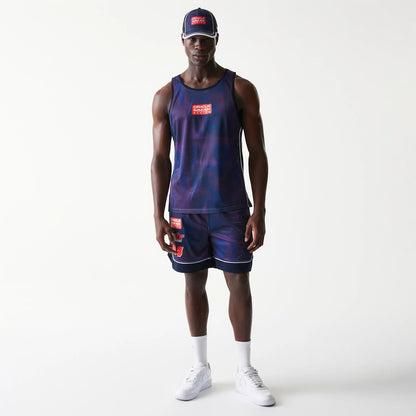 New Era Red Bull Racing Dark Blue Mesh Tank Top, front view on a model wearing matching shorts and a cap, featuring a red and white logo on the chest and a textured pattern across the fabric.