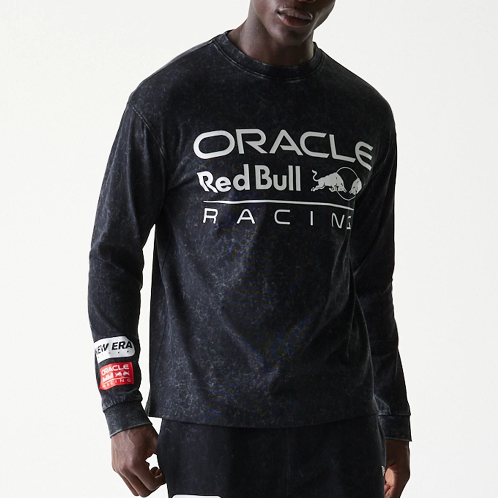 The model is wearing this Red Bull Racing Linear Graphic Long Sleeve T-Shirt in black. 3