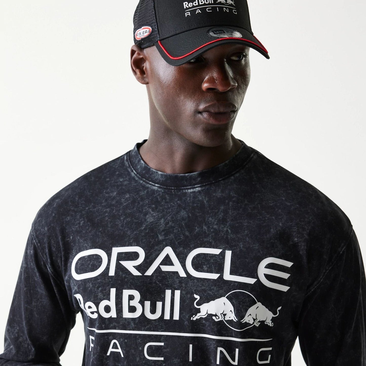 The model is wearing this Red Bull Racing Linear Graphic Long Sleeve T-Shirt in black. 4