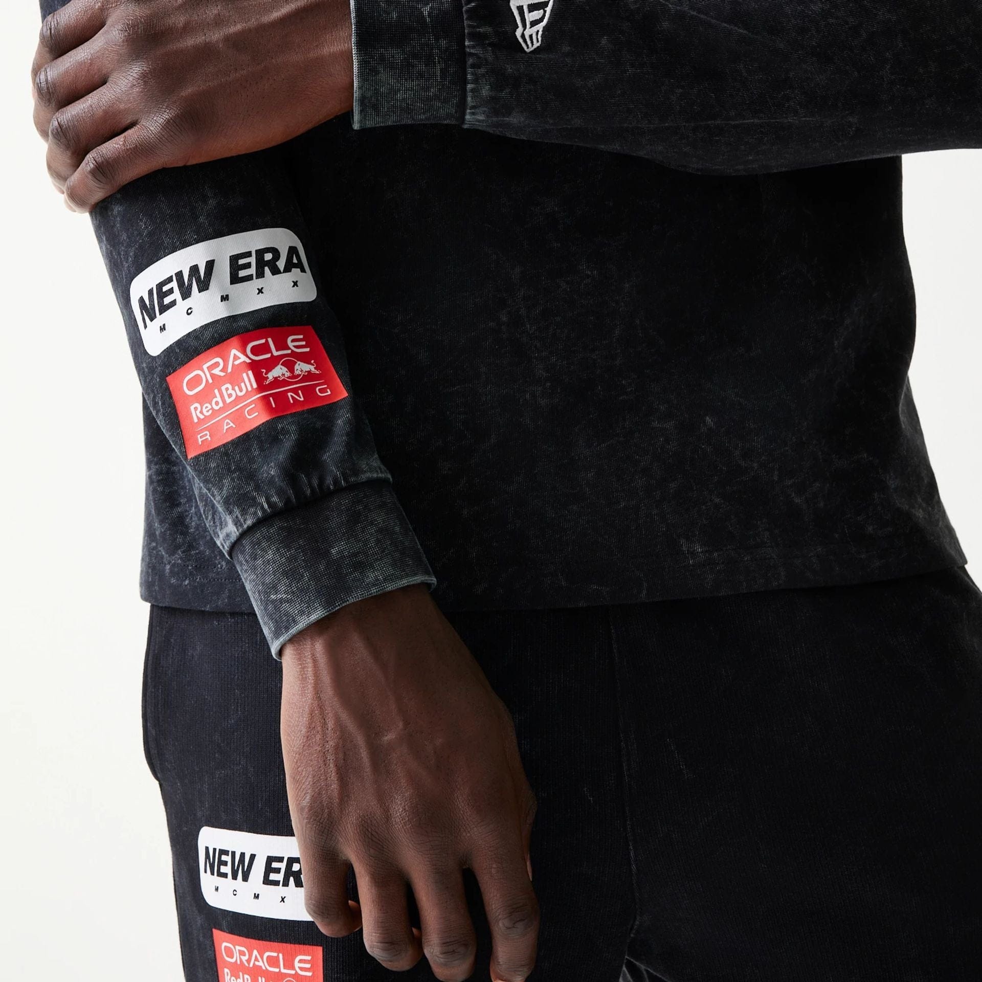 The model is wearing this Red Bull Racing Linear Graphic Long Sleeve T-Shirt in black. 6