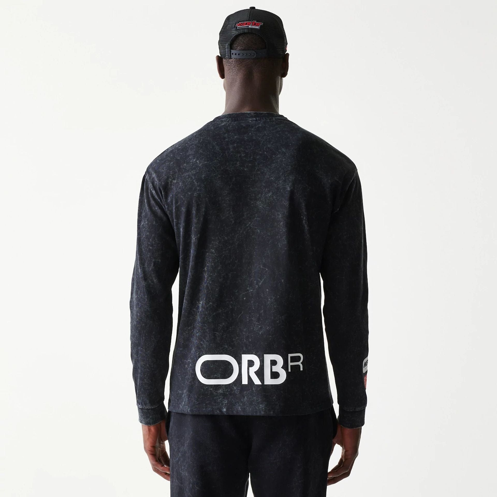 The model is wearing this Red Bull Racing Linear Graphic Long Sleeve T-Shirt in black. 2