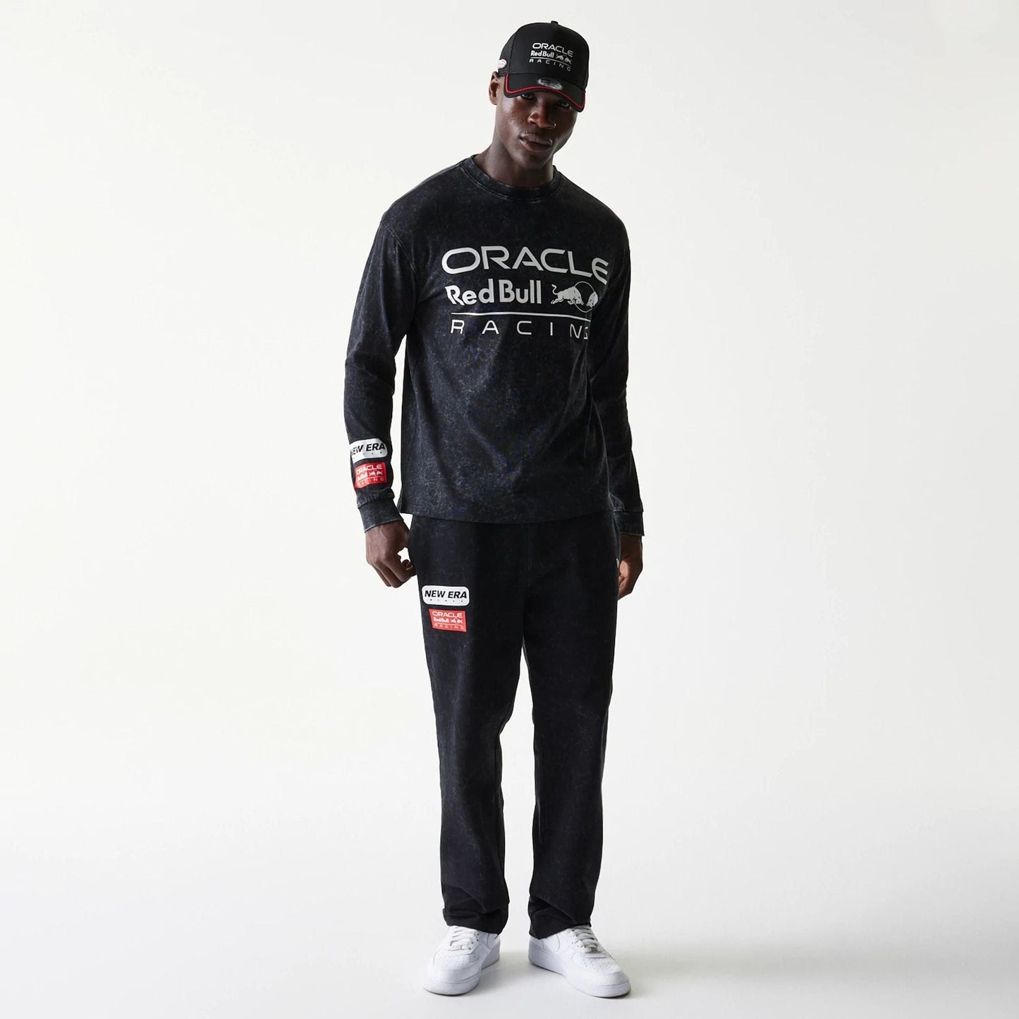 The model is wearing this Red Bull Racing Linear Graphic Long Sleeve T-Shirt in black. 8