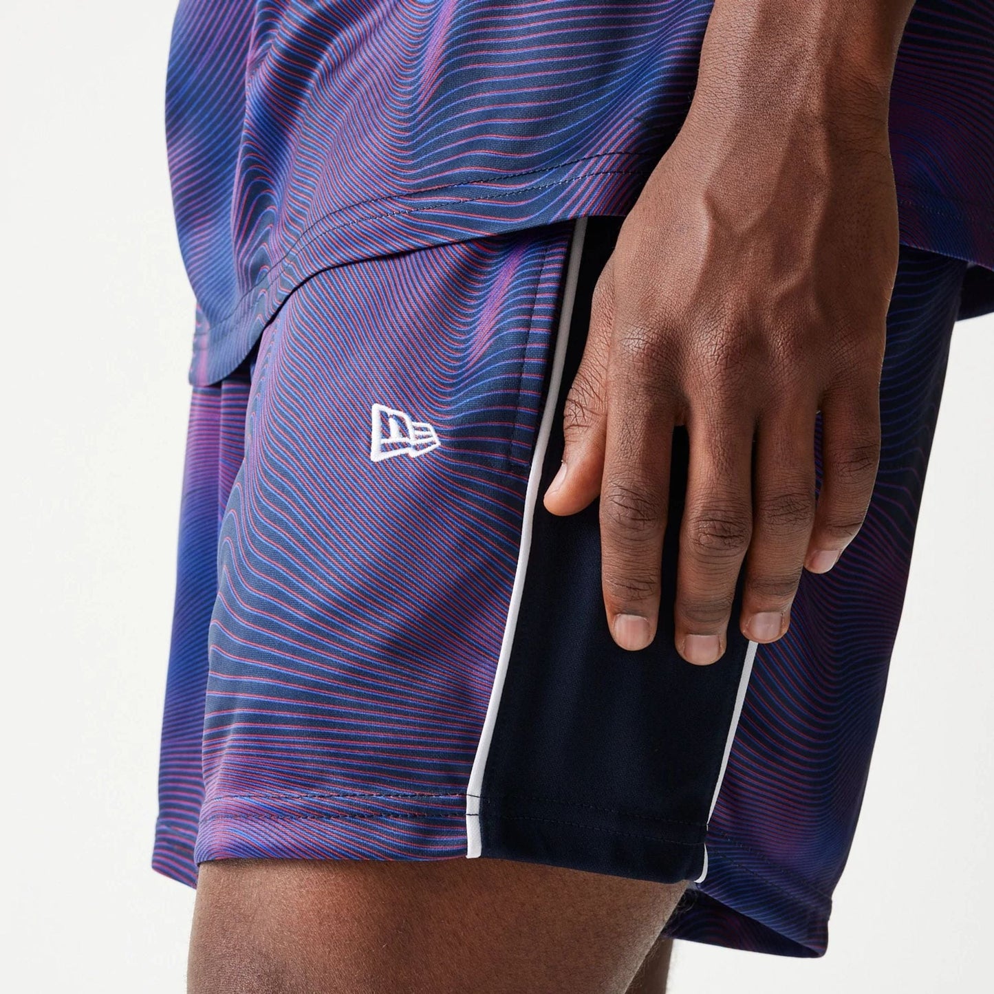 The model is wearing this Red Bull Racing All Over Print Football Shorts in dark blue. 4