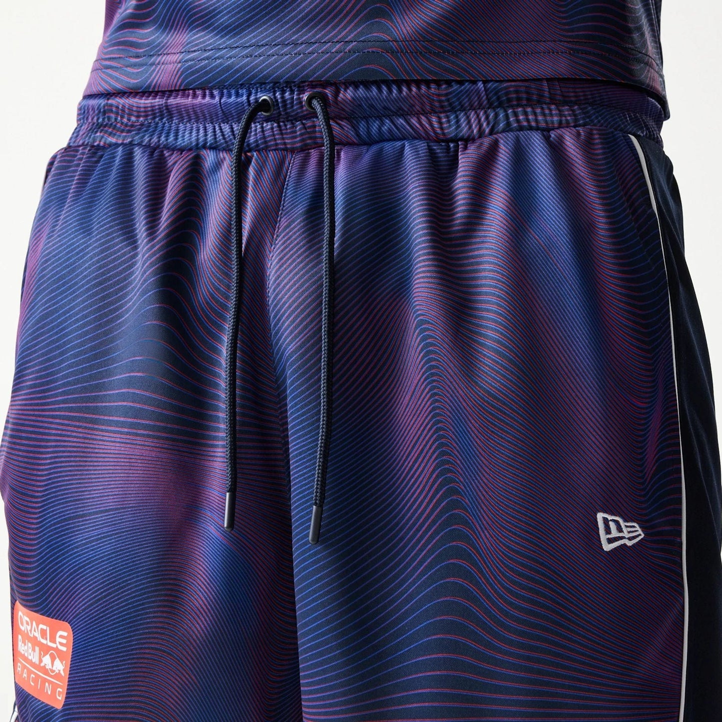 The model is wearing this Red Bull Racing All Over Print Football Shorts in dark blue. 5