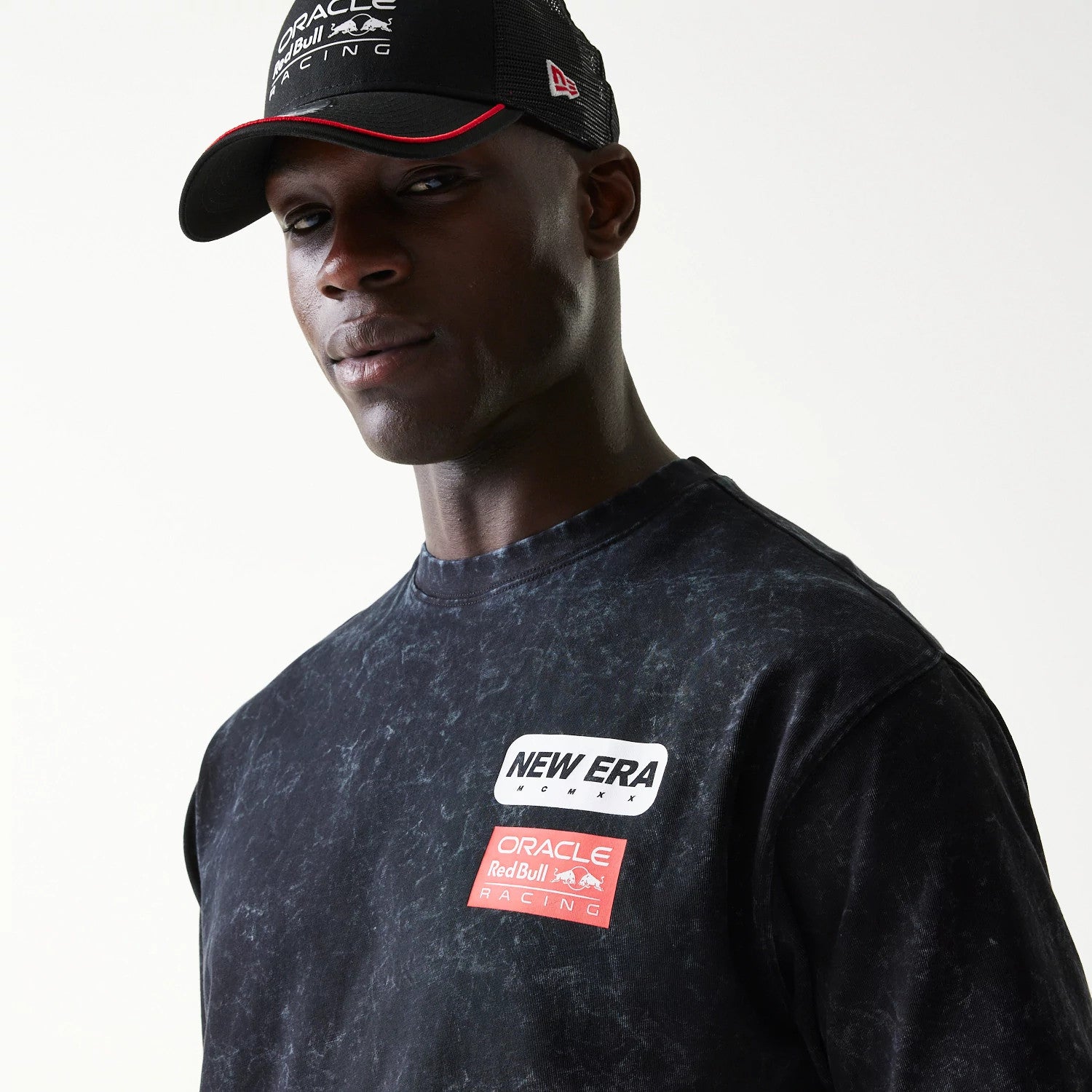 The model is wearing this Red Bull Racing Linear Graphic Oversized T-Shirt in black. 4