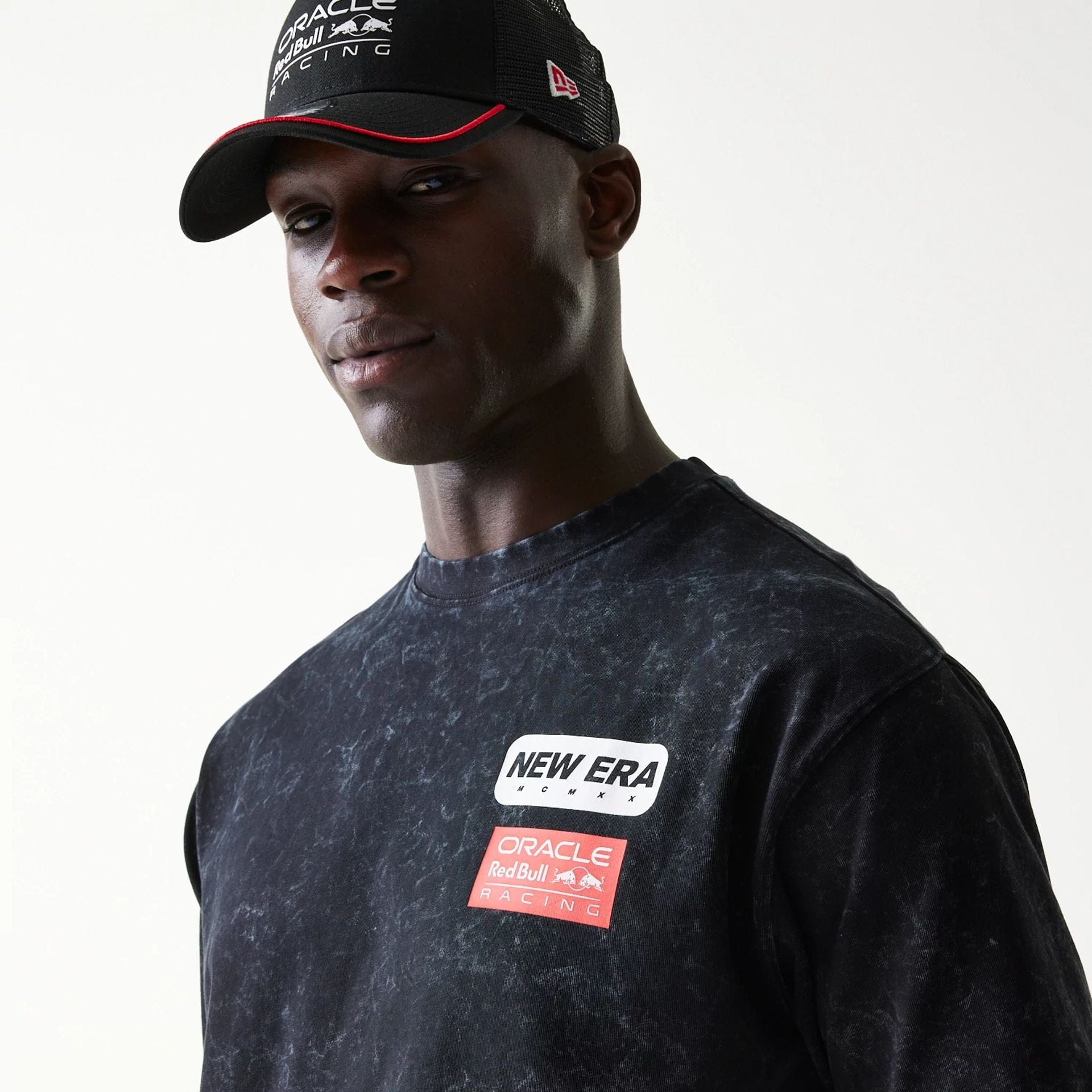 The model is wearing this Red Bull Racing Linear Graphic Oversized T-Shirt in black. 4