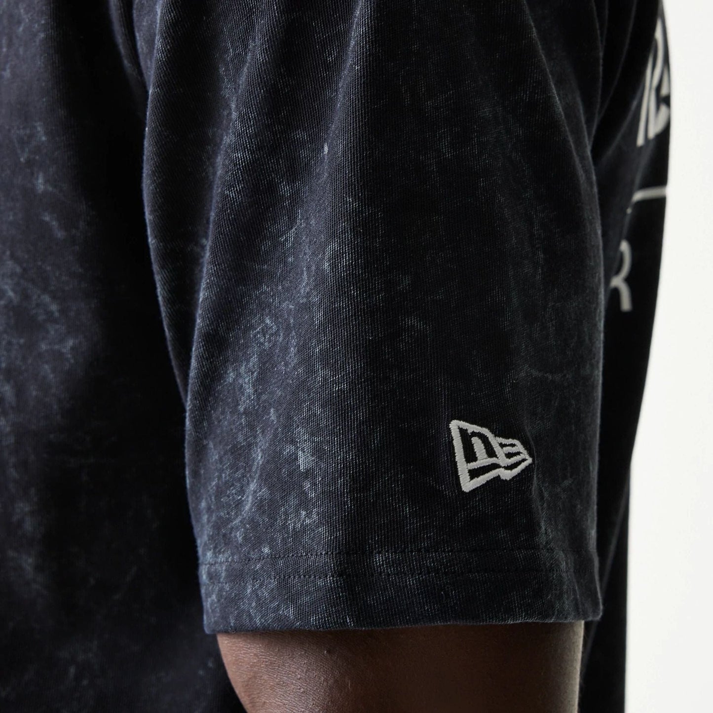 The model is wearing this Red Bull Racing Linear Graphic Oversized T-Shirt in black. 5